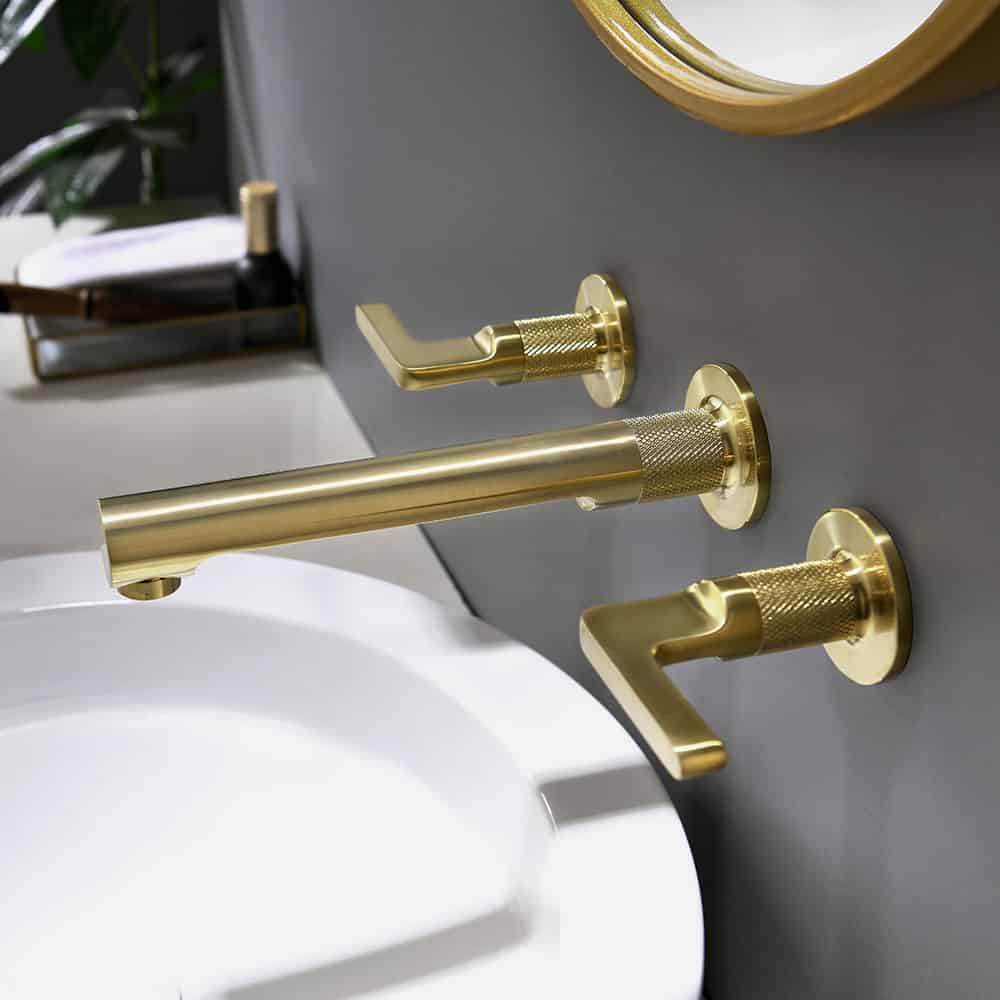 Brushed gold wall mounted bathroom sink tap with knurled